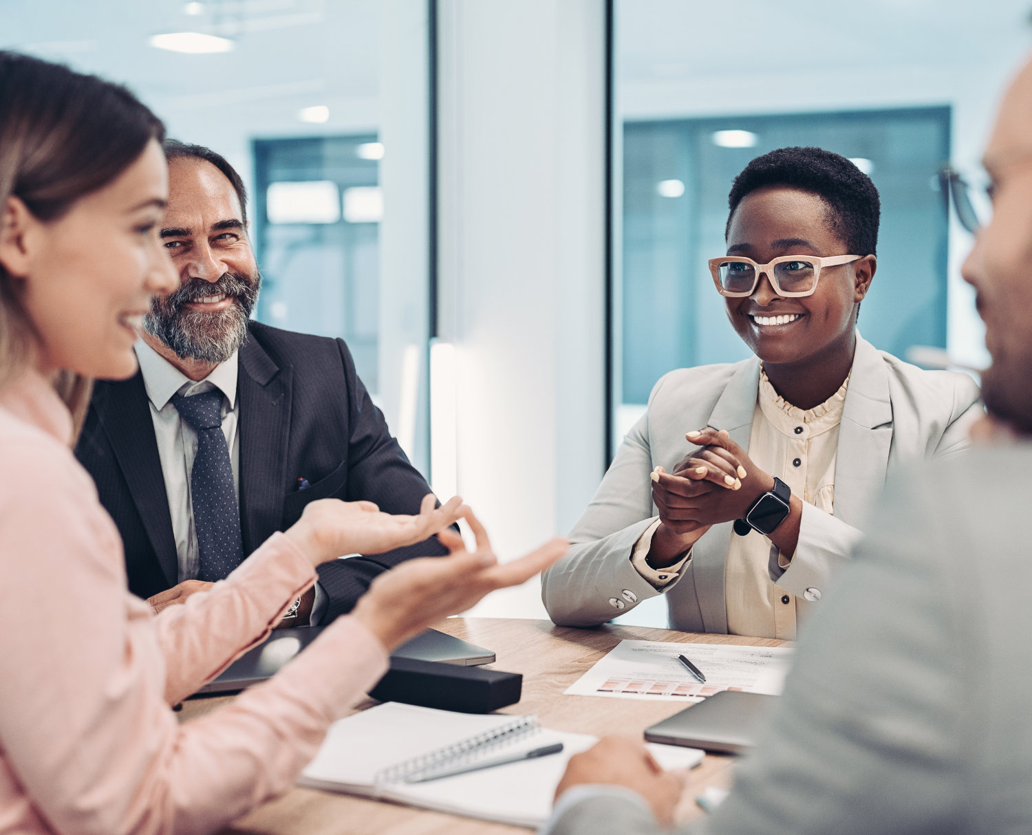 Team collaborating at a table, symbolizing strategic relationship building in bank marketing