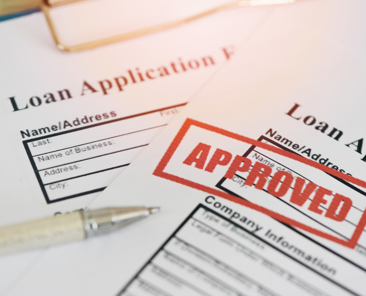Red stamp marking approved on a loan document, symbolizing fast and reliable loan processing.